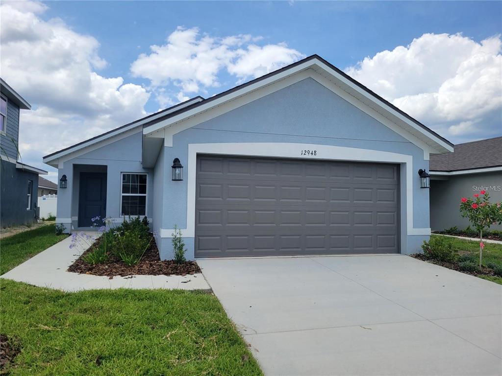 This is a floor plan for a three-bedroom, two-bathroom house with a two-car garage — 9351 HIGHLAND HILLS DR STREET, HUDSON, FL