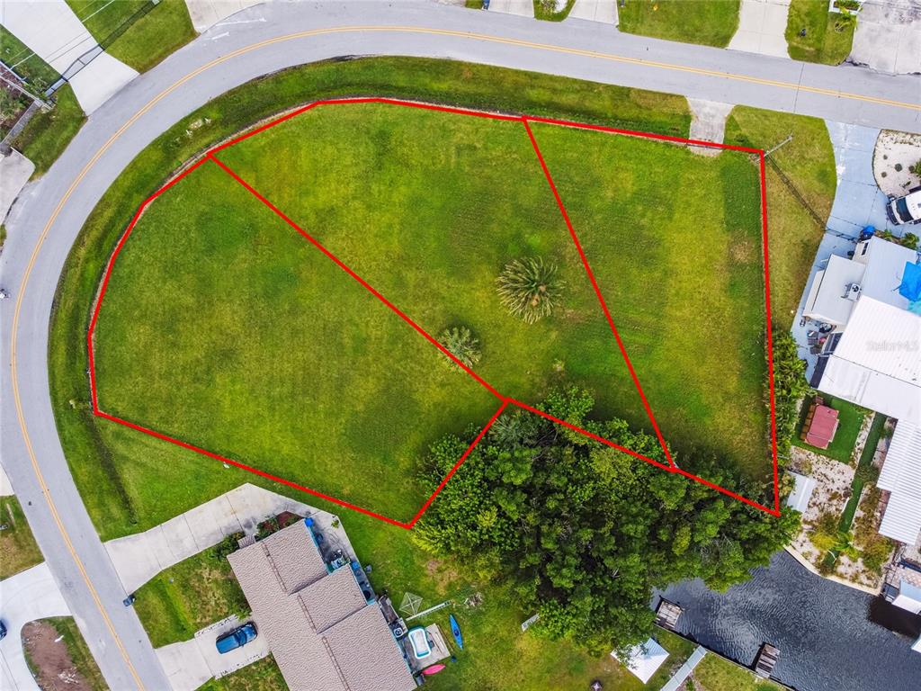 This aerial view shows three adjacent vacant lots bordered by a curved road and water — W SHELL POINT ROAD, RUSKIN, FL