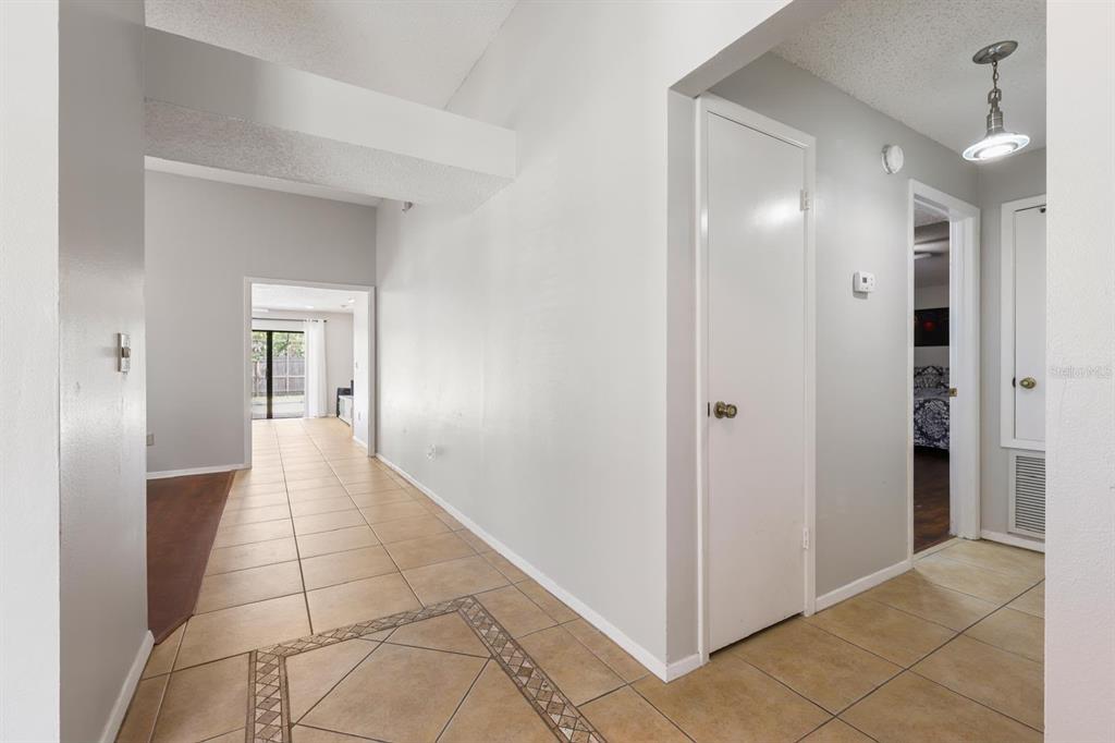 A single-story house with a stone facade, a tan front door, and a concrete walkway — 1912 FIRETHORN COURT, BRANDON, FL