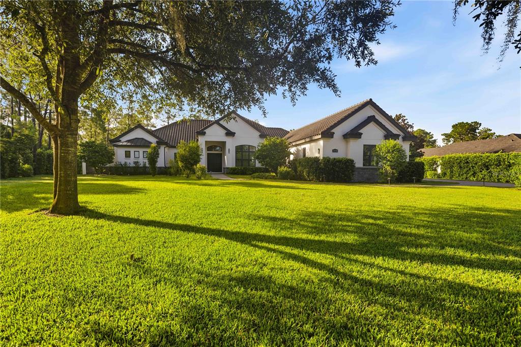 A covered patio with brick pavers overlooks a swimming pool enclosed by a screen cage — 21724 DEER POINTE CROSSING, BRADENTON, FL