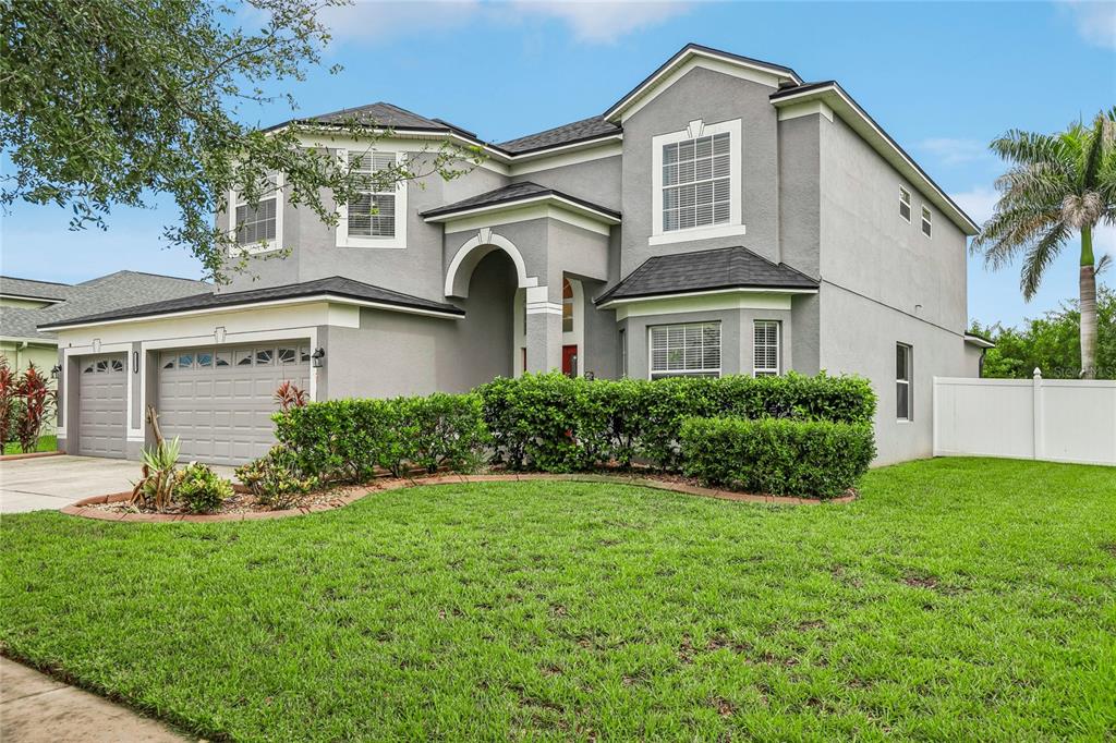 A two-story gray house with a two-car garage and a manicured front lawn — 13231 GRAHAM YARDEN DRIVE, RIVERVIEW, FL