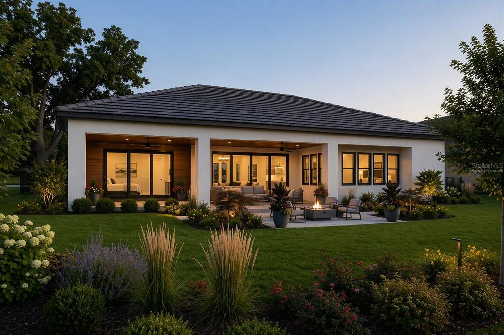 A modern house exterior features a covered patio, large glass sliding doors, and a fire pit — 142 TRANQUIL MIRROR LAKE COURT Lot 18, CLERMONT, FL