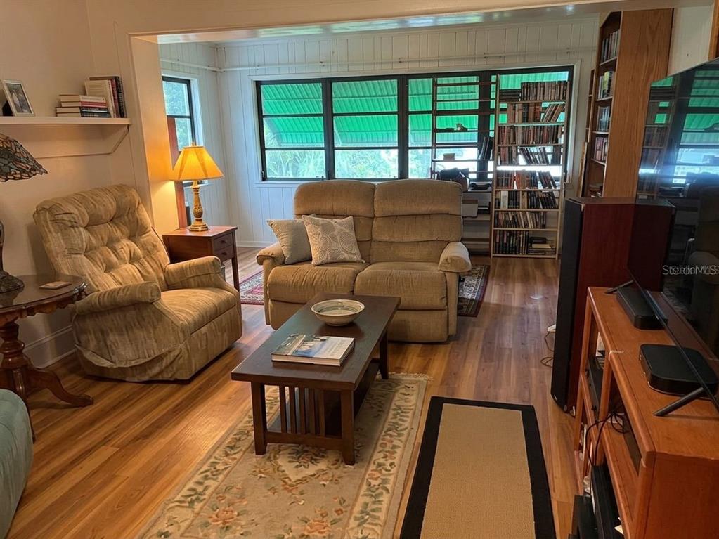 A living room features a beige recliner, a matching loveseat, and a central coffee table — 964 OHLINGER ROAD, BABSON PARK, FL