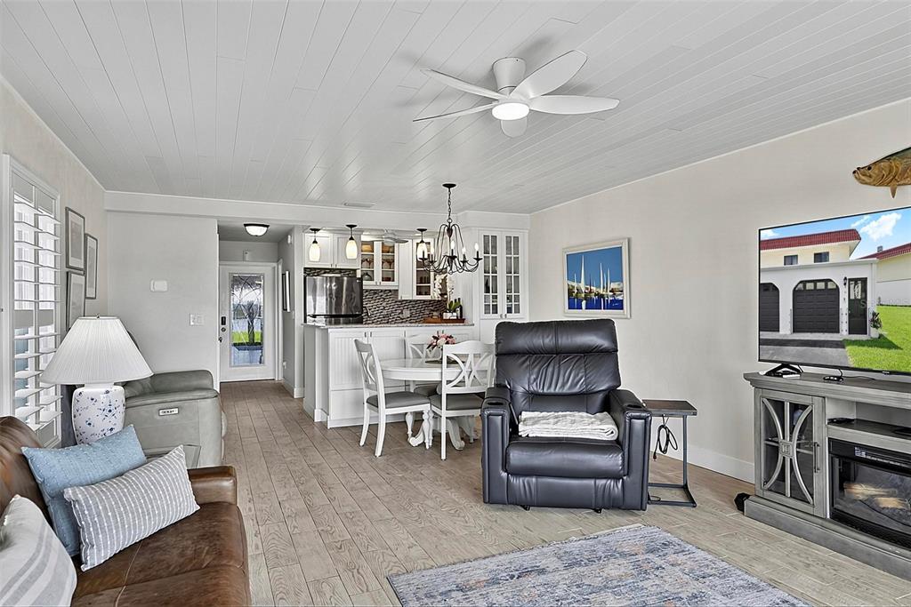 A living room and dining area feature wood-look tile flooring and a white plank ceiling — 51 S OCEAN PALM DRIVE, FLAGLER BEACH, FL