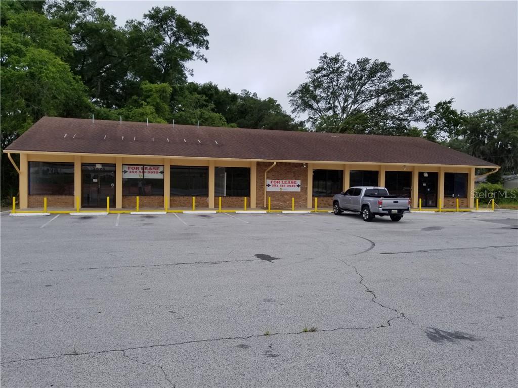 A single-story commercial building with a brown roof and a large paved parking lot — 3520 W HIGHWAY 326 HIGHWAY, OCALA, FL
