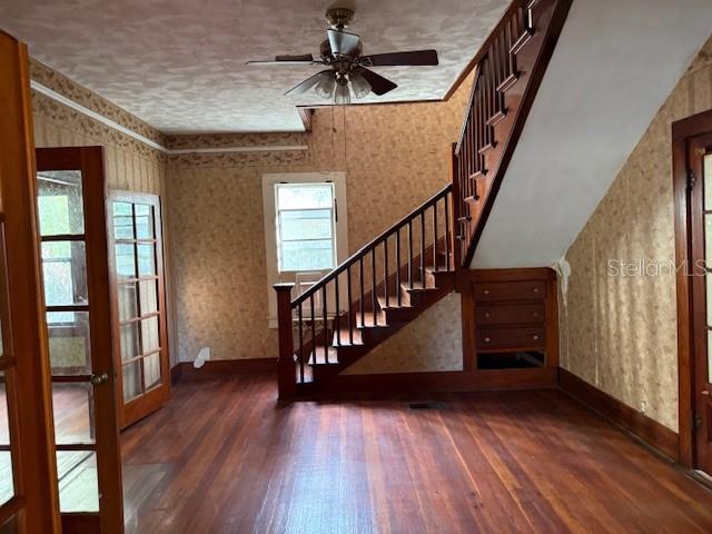 A room with hardwood floors, a wooden staircase, and a ceiling fan — 1600 E LAKEVIEW AVENUE, EUSTIS, FL