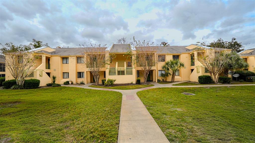 A white front door opens into a tiled entryway with two interior doors and flooring — 4368 S LAKE ORLANDO PARKWAY UNIT 203, ORLANDO, FL