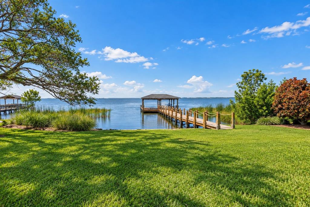 A two-story house with a three-car garage, stone accents, and a brick paver driveway — 243 ZACHARY WADE STREET, WINTER GARDEN, FL