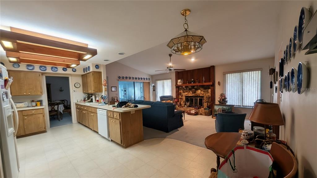 A covered entryway features double brown doors, a hanging lantern, and a stone-accented wall — 7006 120TH STREET, SEMINOLE, FL