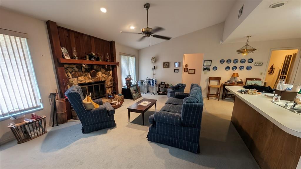 A tiled entryway leads to a carpeted living area with a hanging pendant light fixture — 7006 120TH STREET, SEMINOLE, FL