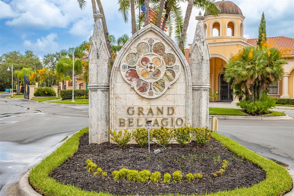 A stone monument sign for Grand Bellagio stands in front of a Mediterranean-style building — 2717 VIA CIPRIANI UNIT 621B, CLEARWATER, FL