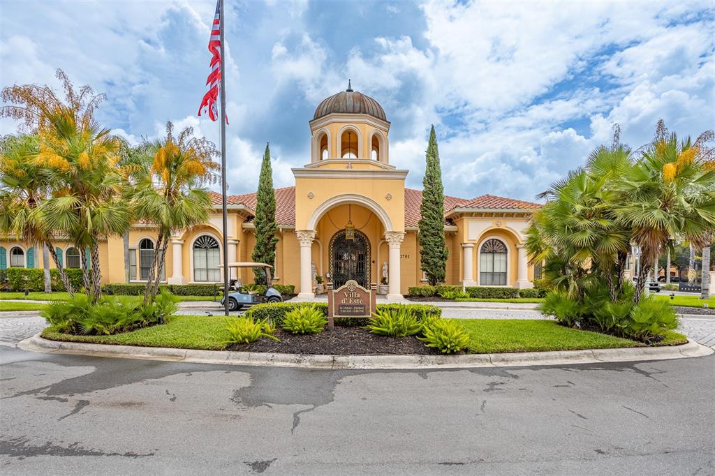 A yellow Mediterranean-style building features a central dome, arched entryway, and a circular driveway — 2717 VIA CIPRIANI UNIT 621B, CLEARWATER, FL