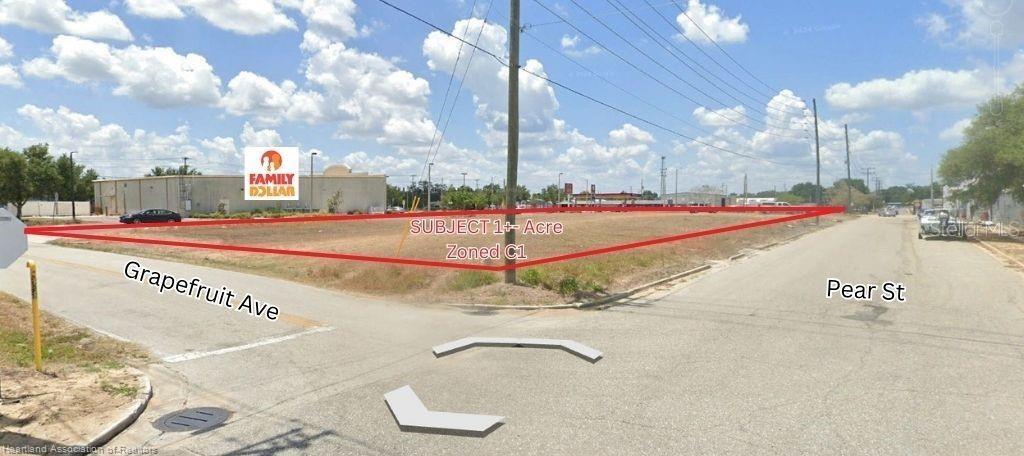 This is a street-level view of a vacant, rectangular lot located at a street corner — 648 N RIDGEWOOD DRIVE, SEBRING, FL