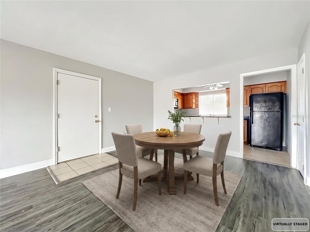A dining area with a round table, four chairs, and a view into the kitchen — 568 ORANGE DRIVE UNIT 50, ALTAMONTE SPRINGS, FL