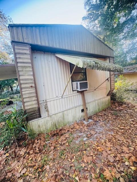 The exterior of a mobile home features vertical siding, a window awning, and a window unit — 4547 CR 692, WEBSTER, FL