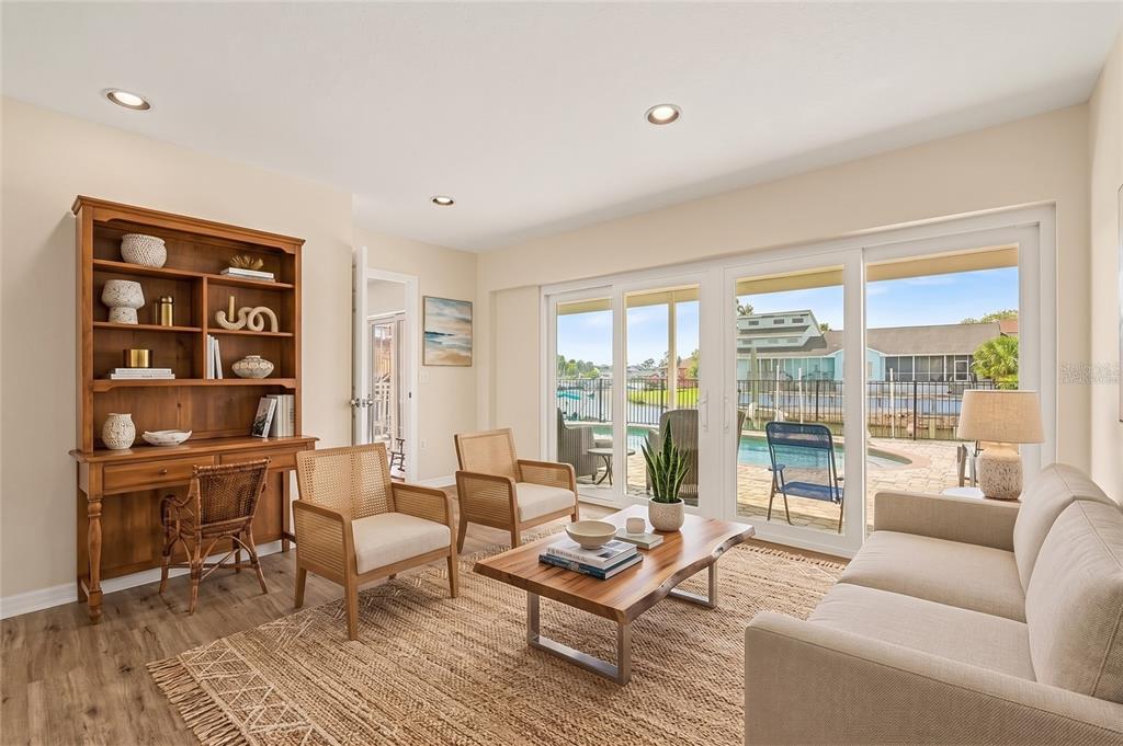 An aerial view shows a house with a red roof, two pools, and a boat dock — 6340 SPOONBILL DRIVE, NEW PORT RICHEY, FL