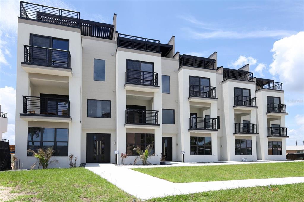 This is a rendering of a multi-story apartment complex with a pool and rooftop terraces — 2360 OCEAN SHORE BOULEVARD UNIT 501, ORMOND BEACH, FL