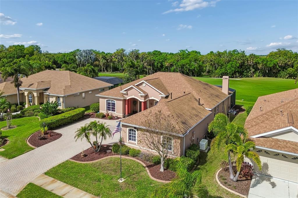 An aerial view of a suburban house with a tan exterior and a brown roof — 566 PLANTERS MANOR WAY, BRADENTON, FL