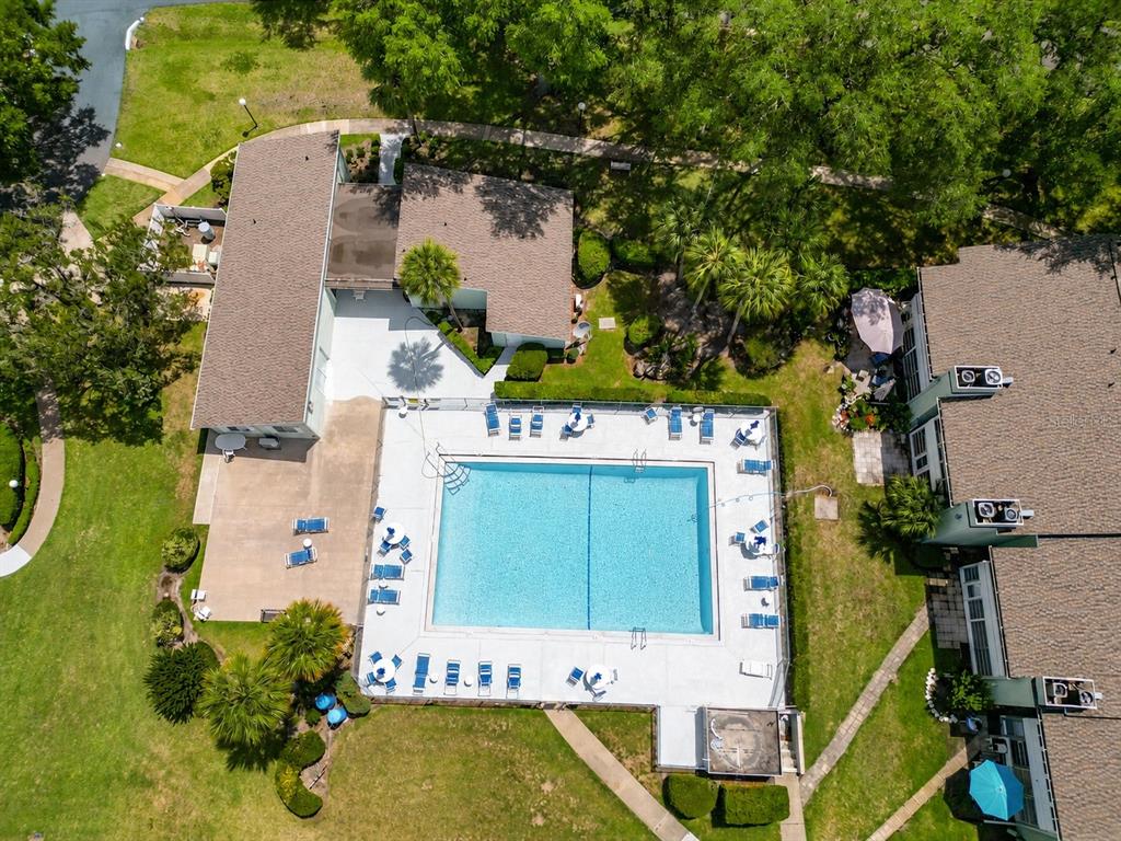 An aerial view shows a rectangular swimming pool surrounded by a patio and lounge chairs — 533 MIDWAY DRIVE UNIT B, OCALA, FL