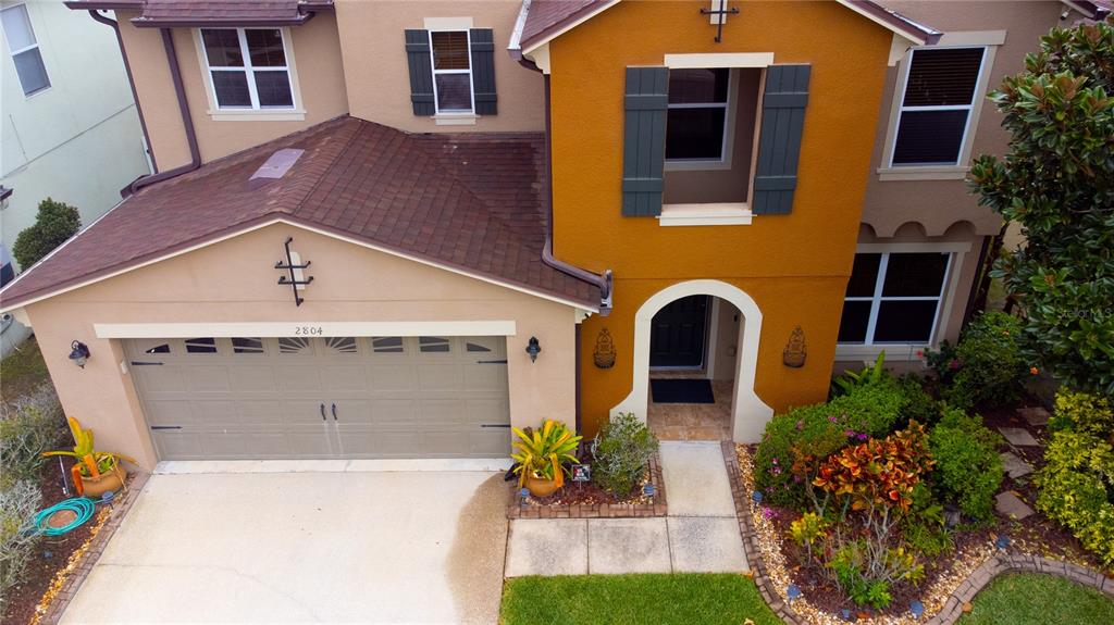 An aerial view shows the front exterior of a two-story house with a garage — 2804 POLSON DRIVE, KISSIMMEE, FL