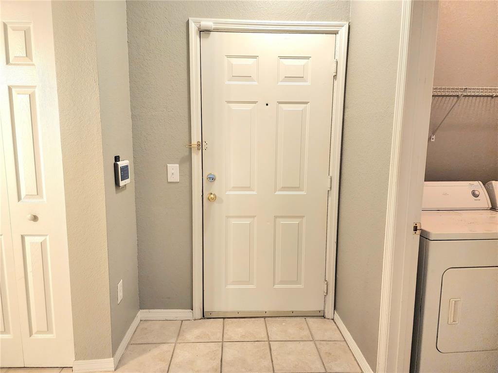 A kitchen features white cabinets, a white refrigerator, a white stove, and tan countertops — 3621 CONROY ROAD UNIT 726, ORLANDO, FL
