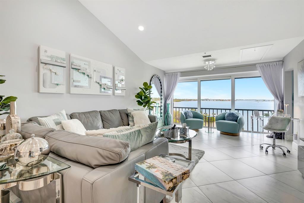 A modern kitchen with grey cabinets, stainless steel appliances, and a view of the water — 1602 STICKNEY POINT ROAD UNIT 404, SARASOTA, FL