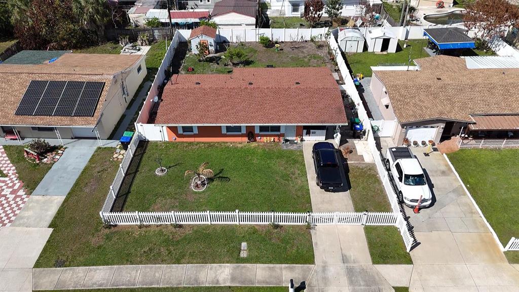 An aerial view shows a single-story house with a brown roof, orange exterior, and fenced yard — 4401 EDGEBROOK, ORLANDO, FL