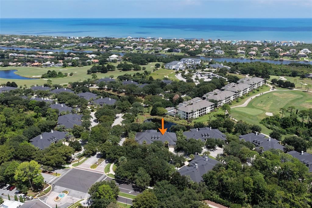 An aerial view shows a residential building with a dark roof nestled among trees — 7 RIVER LANDING DRIVE, PALM COAST, FL