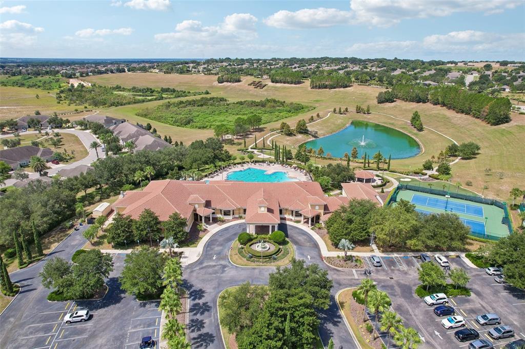 An aerial view shows a community clubhouse with a pool, tennis courts, and parking lot — 2823 MAYPORT STREET, CLERMONT, FL