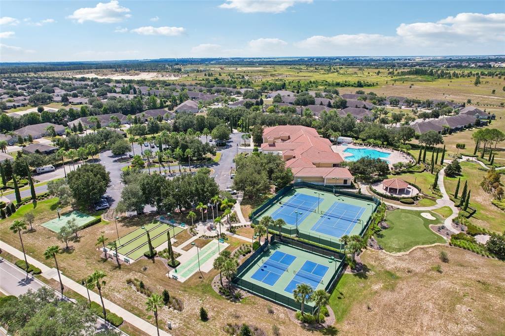 An aerial view of a residential community featuring tennis courts, a pool, and a clubhouse — 2823 MAYPORT STREET, CLERMONT, FL