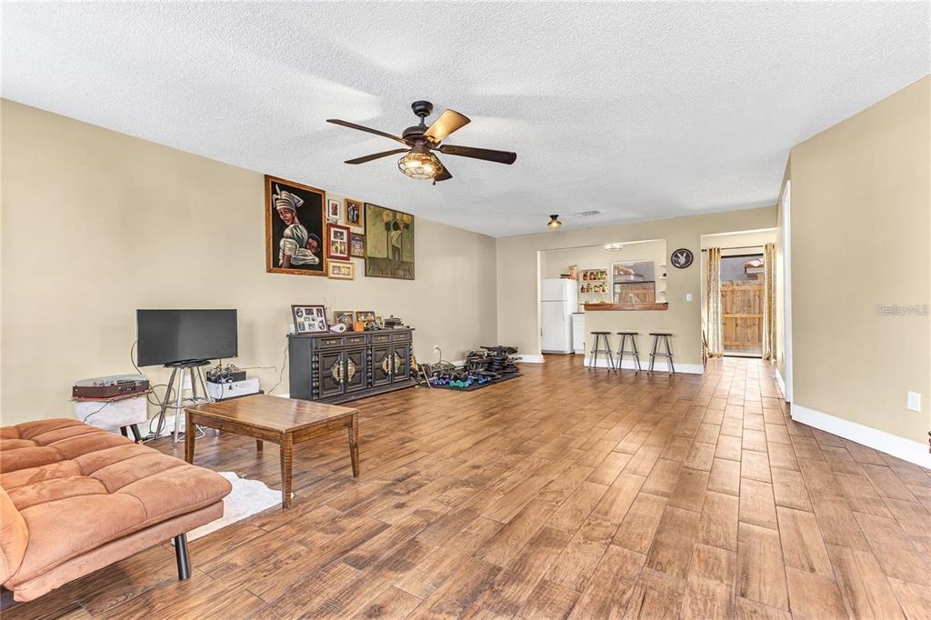 A two-story stucco townhouse with a red-trimmed arched doorway and a tiled roof — 1631 LITTLE FALLS CIRCLE UNIT 92, ORLANDO, FL