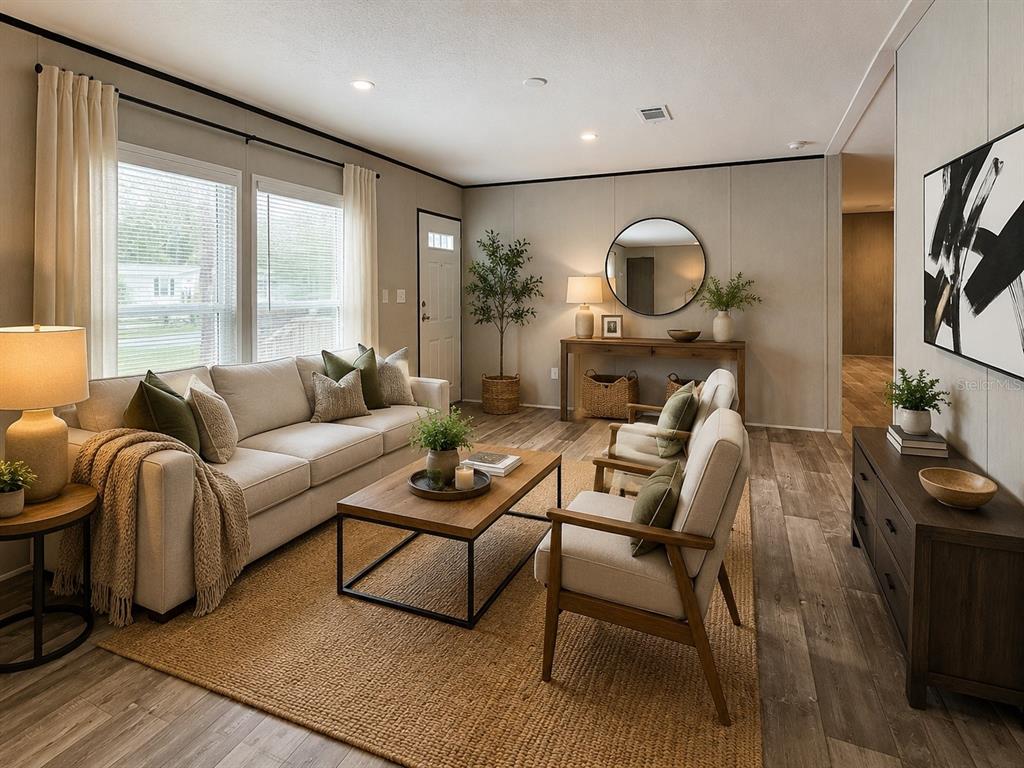 A living room features a beige sofa, two armchairs, a coffee table, and wood flooring — 10055 W OHIO DRIVE, CRYSTAL RIVER, FL