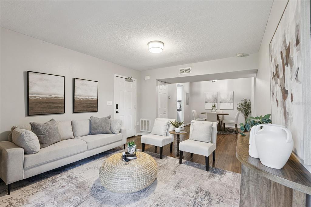 A living room features a light gray sofa, two accent chairs, and a round ottoman — 220 MOREE LOOP UNIT 1, WINTER SPRINGS, FL