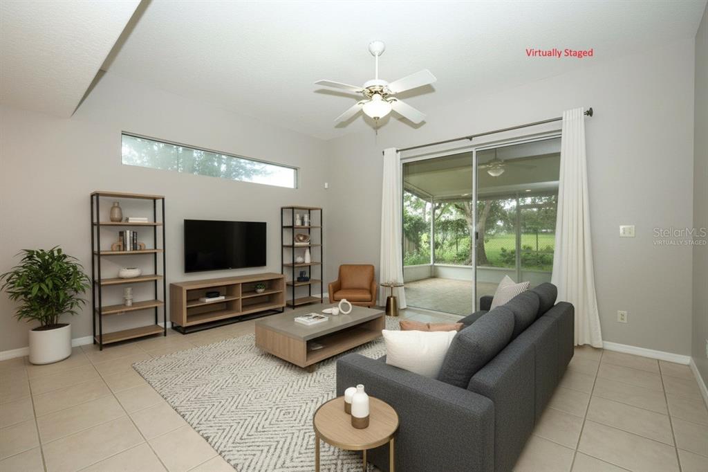 A kitchen features wood cabinets, white appliances, tile flooring, and a breakfast bar — 1730 TEALBRIAR AVENUE, OVIEDO, FL