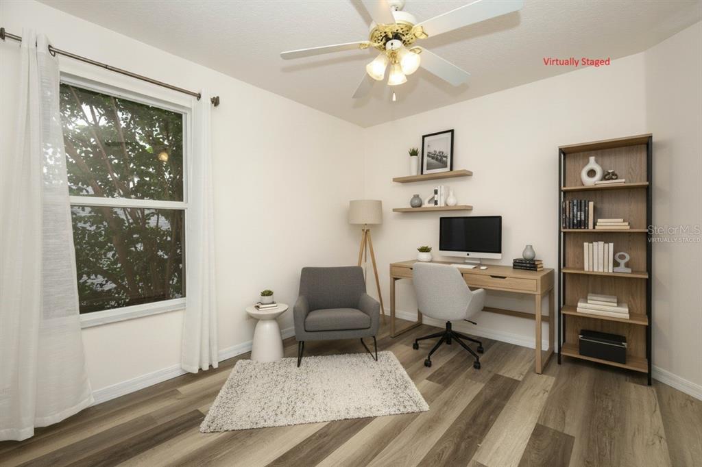 A kitchen with wood cabinets, white appliances, and tile flooring opens to a living area — 1730 TEALBRIAR AVENUE, OVIEDO, FL