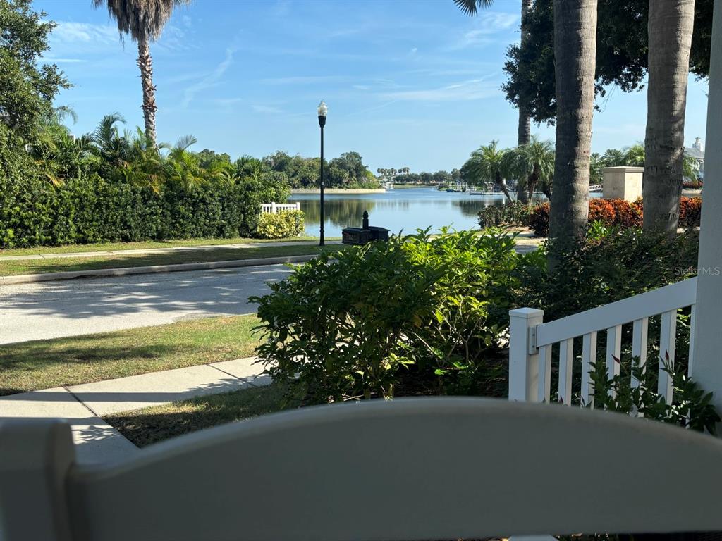 A view of a lake and landscaped grounds from a white porch railing — 310 MANNS HARBOR DRIVE, APOLLO BEACH, FL
