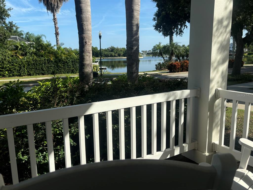 A view of a lake from a white-railed porch with trees and landscaping — 310 MANNS HARBOR DRIVE, APOLLO BEACH, FL