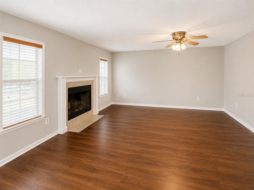 A kitchen features oak cabinets, stainless steel appliances, beige countertops, and light tile flooring — 4104 QUAIL NEST COURT, ST CLOUD, FL