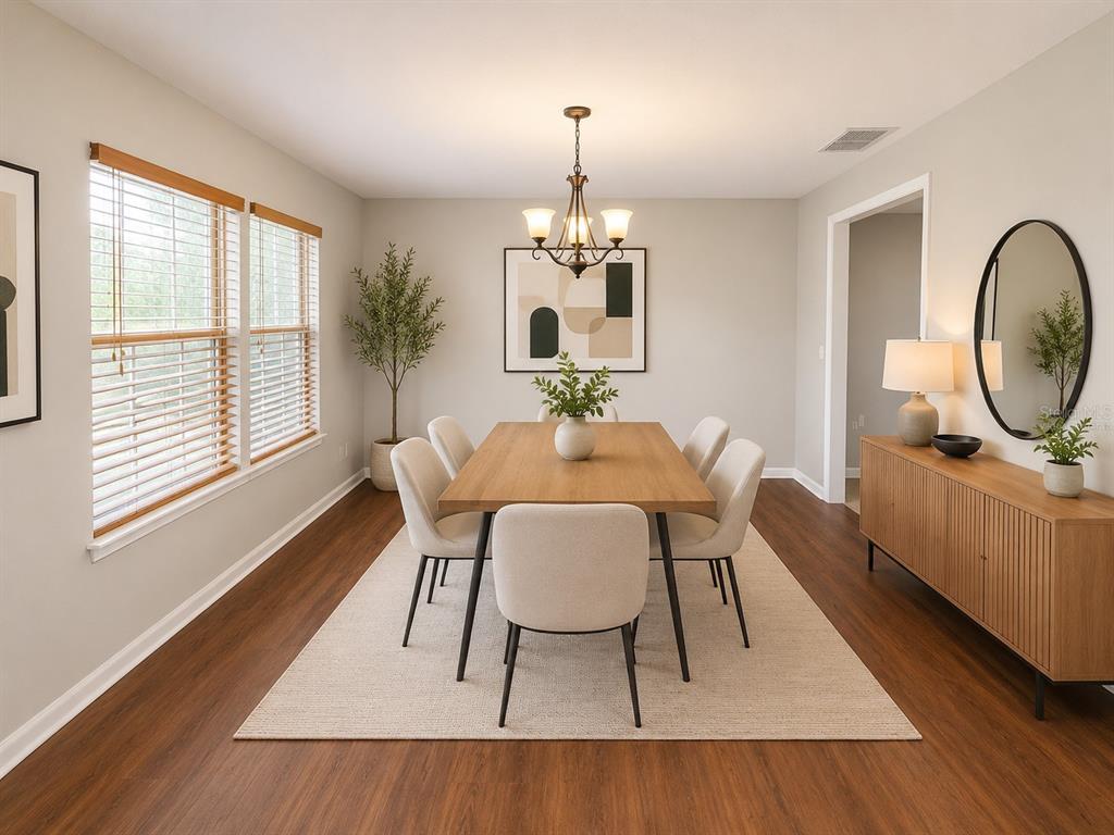 A living room features wood-look flooring, a fireplace, and a ceiling fan — 4104 QUAIL NEST COURT, ST CLOUD, FL