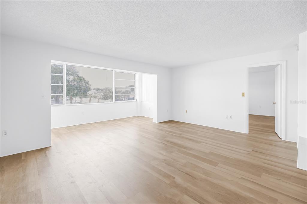 A kitchen features light green cabinets, a drop-in stove, a dishwasher, and a drop ceiling — 1900 68TH STREET N UNIT 210, ST PETERSBURG, FL