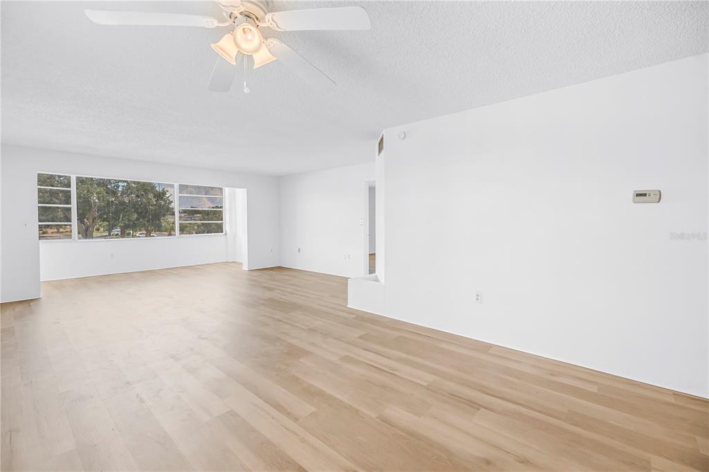 A kitchen features light green cabinets, a white refrigerator, and a yellow drop ceiling — 1900 68TH STREET N UNIT 210, ST PETERSBURG, FL