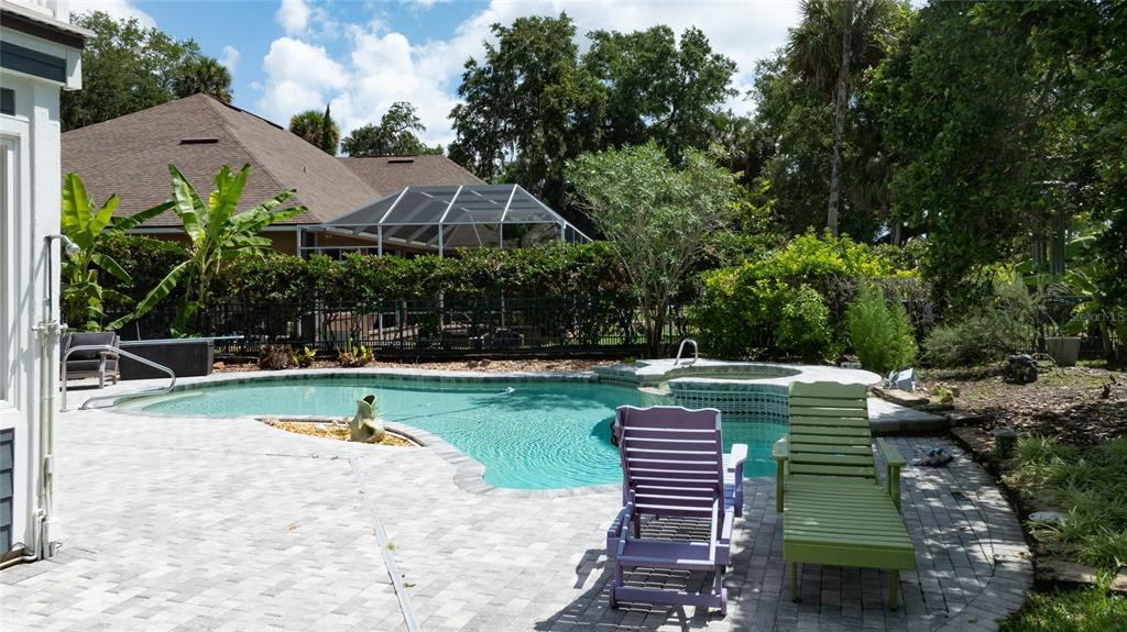 An aerial view shows a large house with a pool near a river and trees — 6315 PALMAS BAY CIRCLE, PORT ORANGE, FL