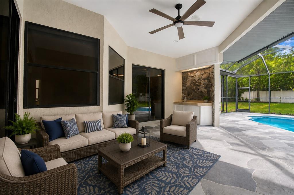 A single-story house with a stone facade, arched entryway, and a curved stone walkway — 18608 AUTUMN LAKE BOULEVARD, HUDSON, FL