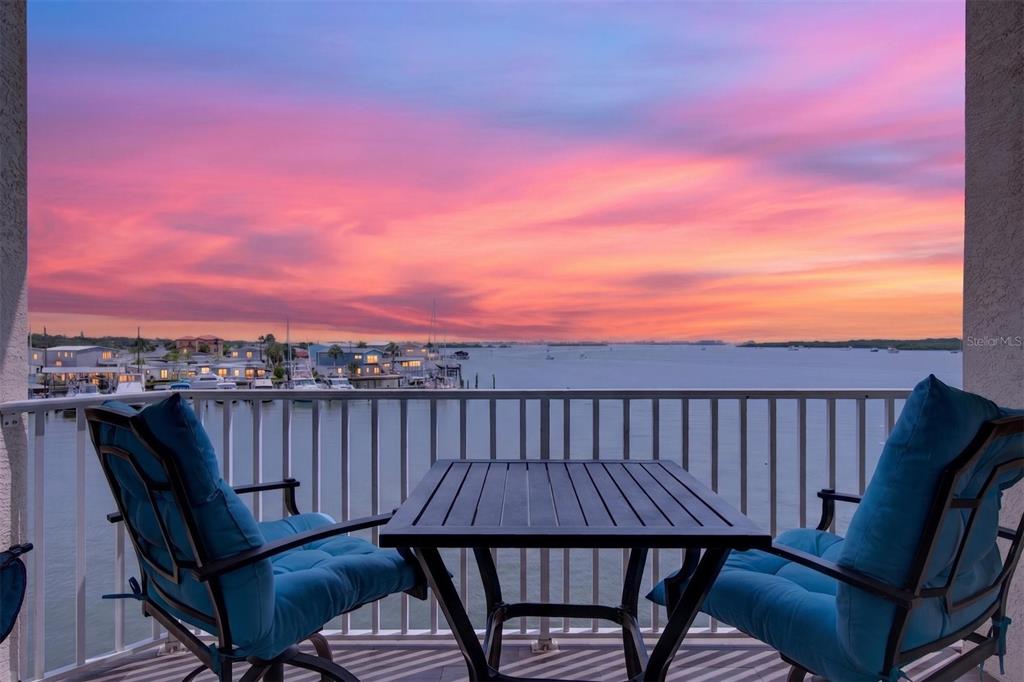 An aerial view of a waterfront apartment building with a pool, hot tub, and dock — 8800 BAY PINES BOULEVARD UNIT 216, ST PETERSBURG, FL