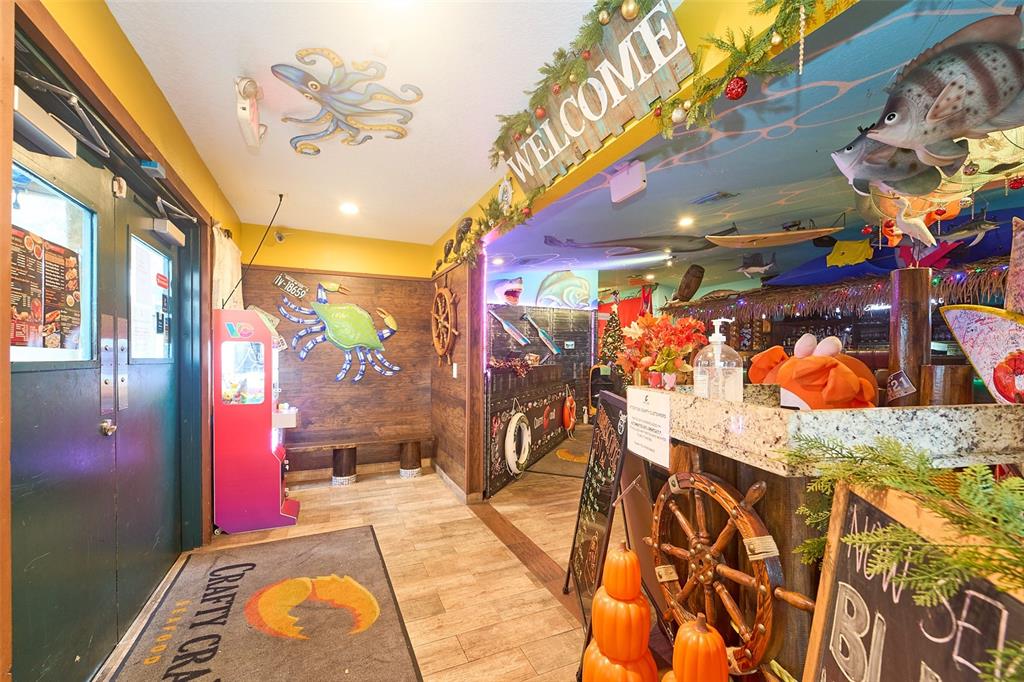The interior of a nautical-themed restaurant features wood-paneled walls, a crab mural, and decorative fish — 704 E BRANDON BOULEVARD, BRANDON, FL