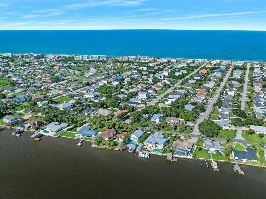 A view of a boat dock with a covered slip and a boat on the water — 3110 JOHN ANDERSON DRIVE, ORMOND BEACH, FL