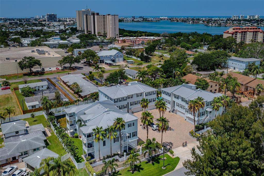An aerial view of a multi-unit residential complex with a paved courtyard and palm trees — 7010 GREVILLA AVENUE S, SOUTH PASADENA, FL