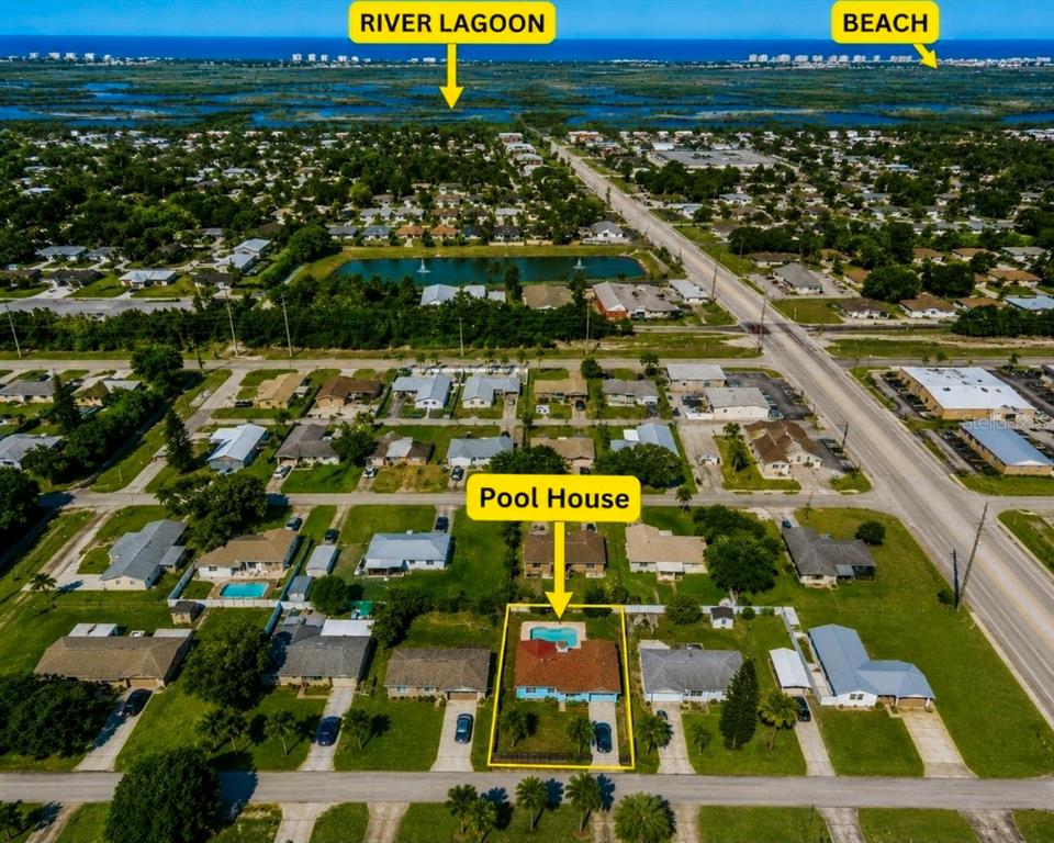 An aerial view shows a residential neighborhood with a highlighted house featuring a backyard pool — 1819 JUNIPER DRIVE, EDGEWATER, FL