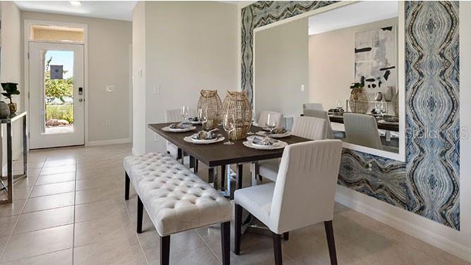 A dining room features a wooden table with a bench, chairs, and a large wall mirror — 8310 PONCE DE LEON STREET, LAKELAND, FL