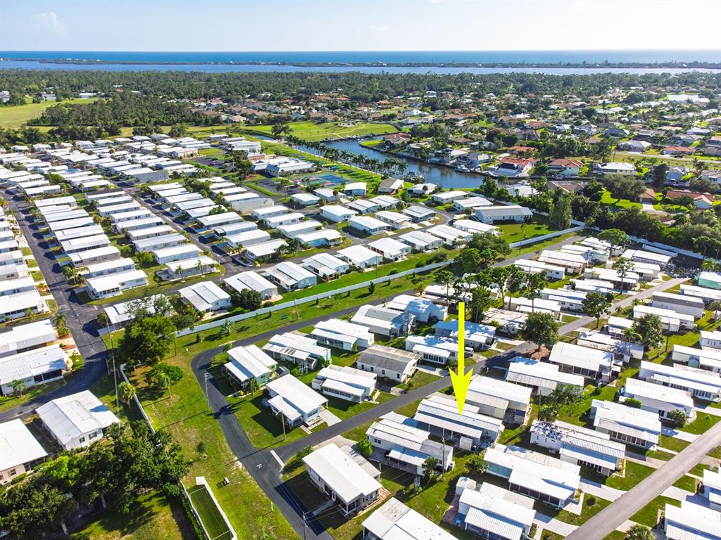 An aerial view shows a mobile home community with a yellow arrow pointing to a unit — 1800 ENGLEWOOD ROAD UNIT 137, ENGLEWOOD, FL